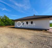 A family house in Harichovce with a white facade and surroundings prepared for landscaping.