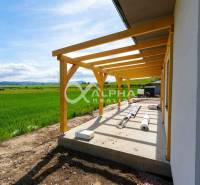 A family house in Harichovce with a terrace construction and a view of the green landscape.