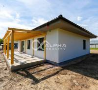 A family house in Harichovce with a roof and a new pergola, terrain prepared for landscaping.
