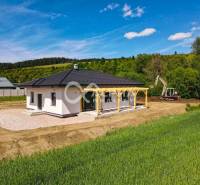 A family house in Harichovce with a view of the green field and forest.