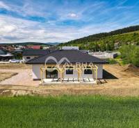 A family house in Harichovce with a new building, pergola, and panoramic view of nature.
