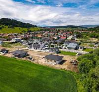 Beautiful view of family houses in Harichovce with the surrounding green landscape.
