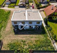 A family house in Harichovce in the exterior, surrounded by greenery and neighboring houses.