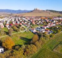 Aerial view of residential plots in Spišské Podhradie with a panorama of the castle.