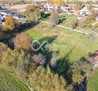 Residential plots in Spišské Podhradie surrounded by greenery and neighboring houses.