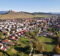 Aerial view of residential land in Spišské Podhradie with the castle in the background.