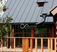 Exterior of a family house in Hnilčík with a metal roof and wooden elements.