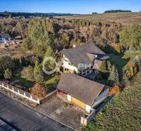 A family house in Veľká Lomnica surrounded by greenery with a garden and a wide view of the surroundings.