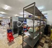 A store with shelves and goods, a floor with a wooden decor, interior of a building.