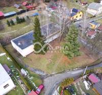Aerial view of a building in Helcmanovce surrounded by trees and gardens.