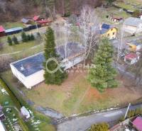 A view from above of a building in Helcmanovce surrounded by trees and gardens.
