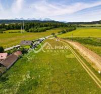 Plots - housing in Betlanovce with green meadows and houses in the background.