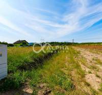 Plots - housing in Betlanovce, grass, field, electrical cabinets, house and blue sky.