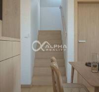 Interior with a staircase, wooden decor flooring, and wooden furniture. Real estate - housing.