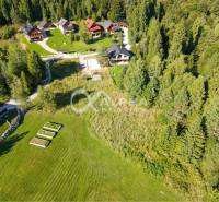 Aerial view of properties - housing in Spišské Vlachy surrounded by forest and houses.