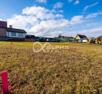 Residential plots in Spišské Tomášovce with open countryside and surrounding houses.