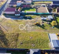 Aerial view of residential plots in Spišské Tomášovce, with visible machinery.