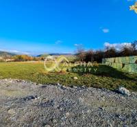 Residential plots in Markušovce, open landscape, grassy areas, and rural environment.