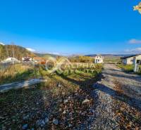 Plots - housing in Markušovce surrounded by greenery, visible buildings and access road.