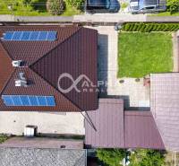 Aerial view of a family house in Spišská Nová Ves with two solar panels and a garden.
