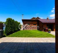 A garden of a family house in Spišská Nová Ves with a lawn and a terrace.
