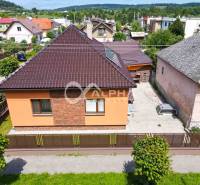 A family house in Spišská Nová Ves with a sloped roof and a landscaped yard.