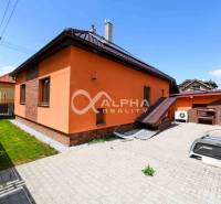 A family house in Spišská Nová Ves with an orange facade and a paved courtyard.