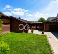 Garden and garage at a family house in Spišská Nová Ves with a paved driveway.