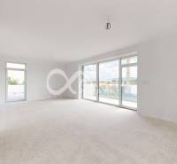 A spacious living area with large windows and balcony doors in a 3-room apartment.