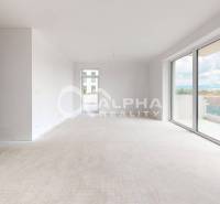 A bright space of a 3-room apartment with large windows and a view.