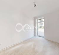 A bright room with white walls and a beige floor in a 3-room apartment.