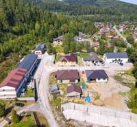 An aerial view of a village surrounded by forests and houses near Spišská Nová Ves.
