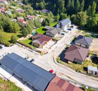 Aerial view of new houses in Spišská Nová Ves surrounded by greenery and streets.