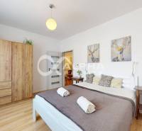 Bedroom in a 2-room apartment with wood decor and a comfortable bed.
