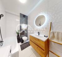 Bathroom with a shower, bathtub, wooden sink, and illuminated mirror in a 2-room apartment.