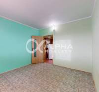 A room in a 3-room apartment with blue walls and a wooden decor floor.