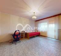 A sofa set, a work desk, and curtains in the room of a 3-room apartment.