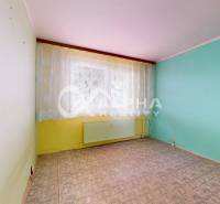 A room with colorful walls, a large window, and a carpet in a 3-room apartment.