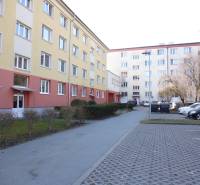 Apartment building on 17. novembra Street in Prešov with a parking lot in the foreground.