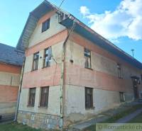 A family house in Východná with a plastered facade and a satellite dish on the wall.