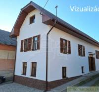 A family house in Východná with a white facade and wooden shutters.