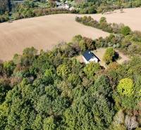 Aerial view of agricultural and forest land near Lackov surrounded by trees and fields.