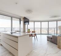 A spacious living area with large windows in a 3-room apartment, city view.