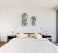 Bedroom in a 3-room apartment with a view and wall decorations, floor with wooden decor.
