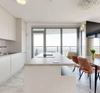 A kitchen in a 3-room apartment with a dining table and a panoramic view.