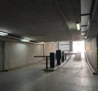 Underground garage with a ramp and the sign Private Parking.