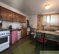 A cottage kitchen with wooden decor and simple furnishings.
