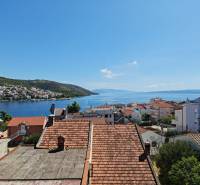 View from a holiday apartment in Ciovo over rooftops and the azure sea.