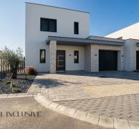 The family house in Gyor-Moson-Sopron has a minimalist facade with a garage and a landscaped garden.