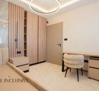 Bright room in a family house with a desk, light carpet, and wooden decor.